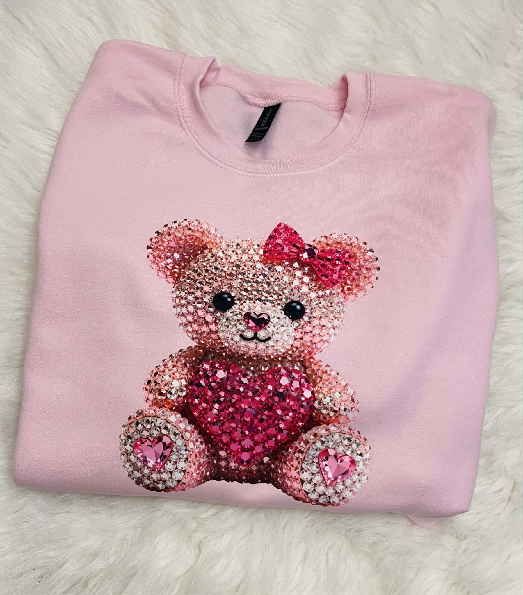 pink bear on pink sweatshirt